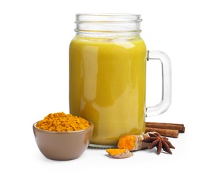 Delicious turmeric latte in mason jar and spices isolated on white