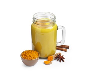 Photo of Delicious turmeric latte in mason jar and spices isolated on white