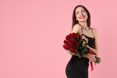 Photo of Happy Valentine's Day. Beautiful woman with bouquet of roses on pink background. Space for text