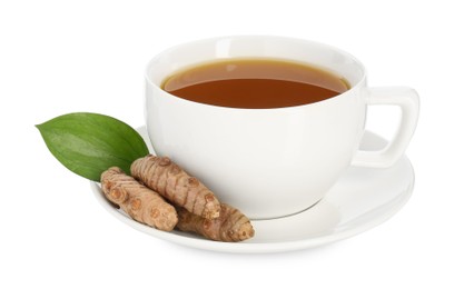 Photo of Aromatic turmeric tea in cup, roots and green leaf isolated on white