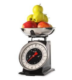 Photo of Retro mechanical kitchen scale with apples isolated on white