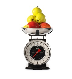 Photo of Retro mechanical kitchen scale with apples isolated on white