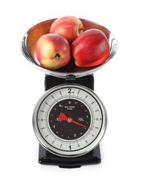 Photo of Retro mechanical kitchen scale with apples isolated on white