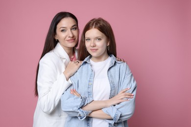 Photo of Family portrait of beautiful mother with teenage daughter on pink background