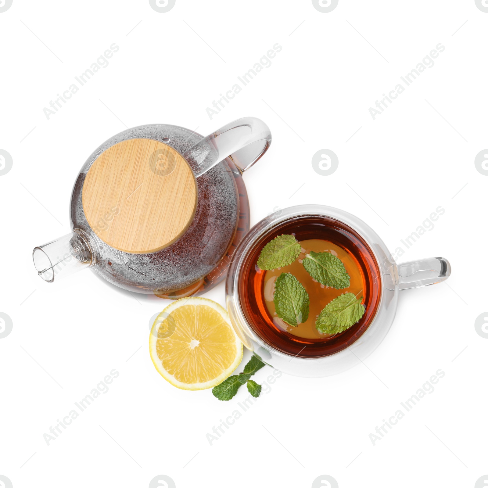 Tasty mint tea, lemon and fresh leaves isolated on white, top view Photo of Tasty mint tea, lemon and fresh leaves isolated on white, top view