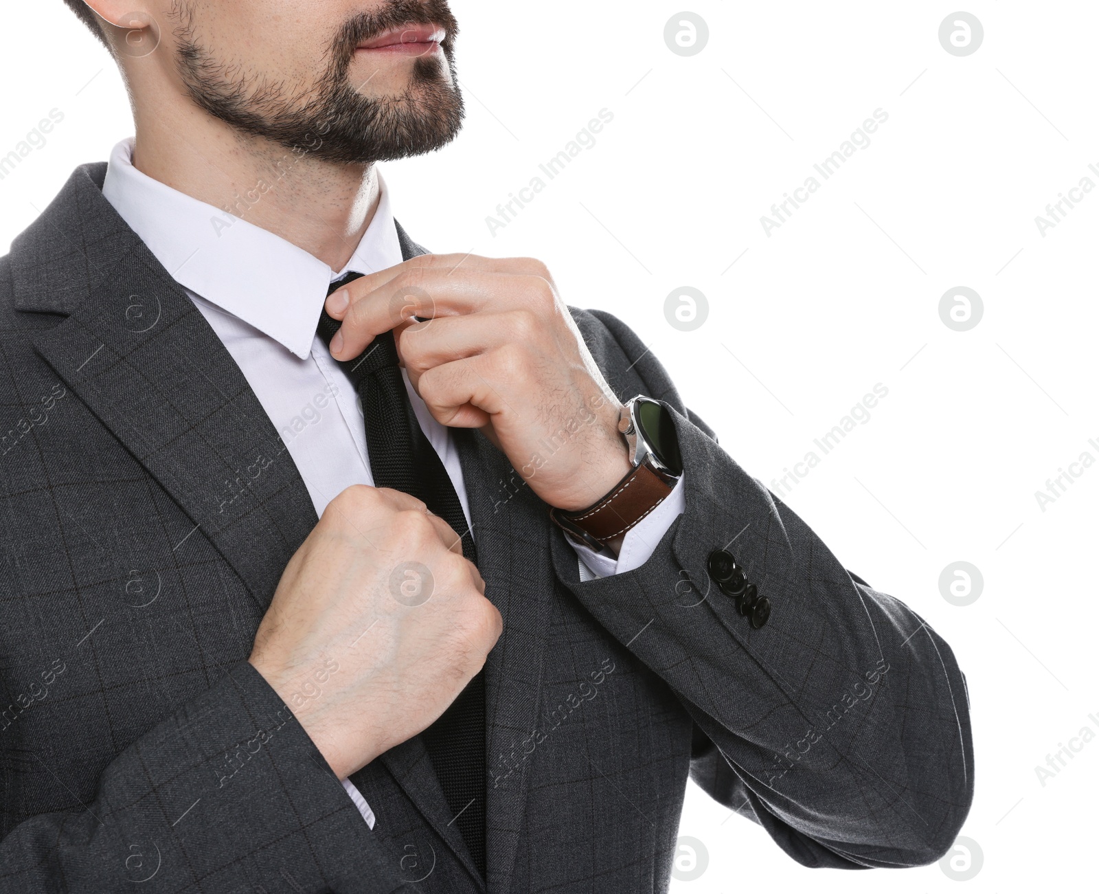 Photo of Man in classic suit straightening tie on white background, closeup