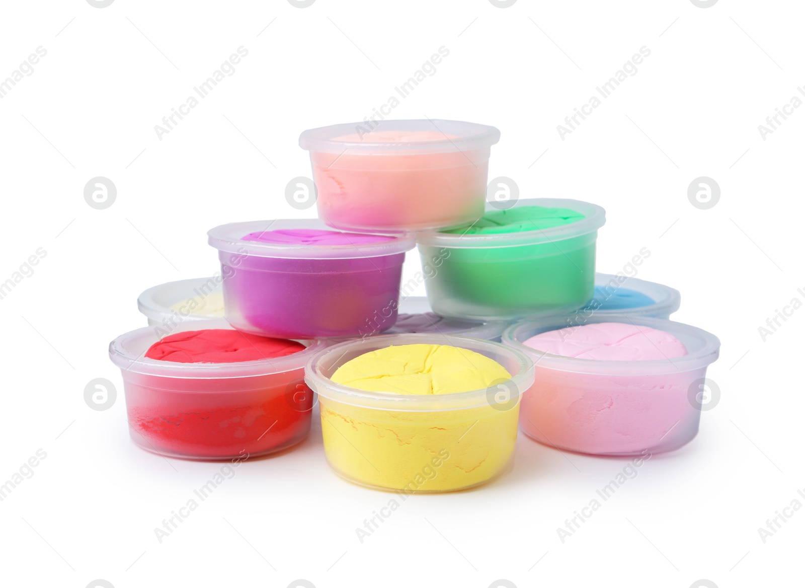 Photo of Different colorful modeling clay in plastic jars isolated on white