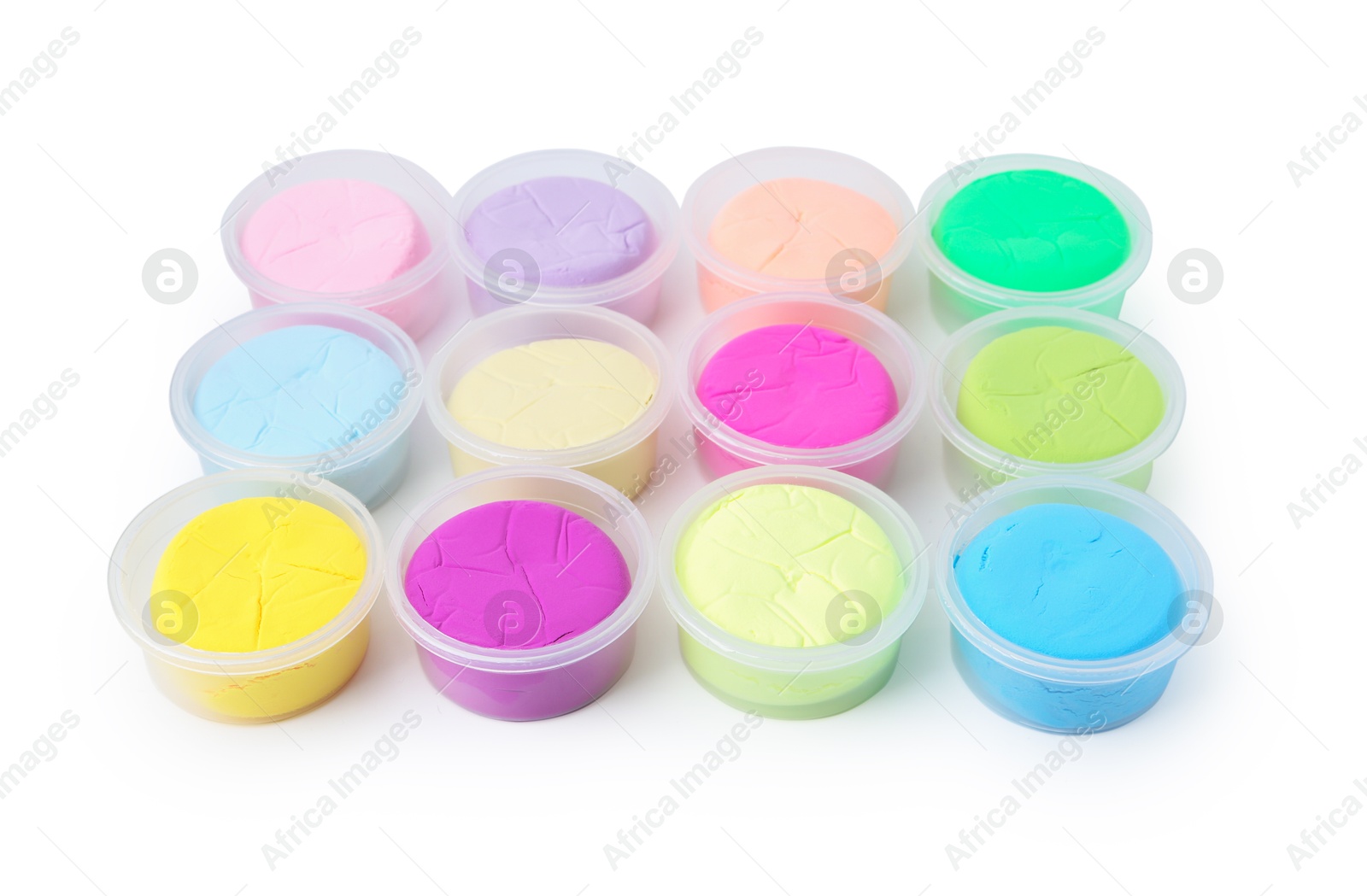 Photo of Different colorful modeling clay in plastic jars isolated on white