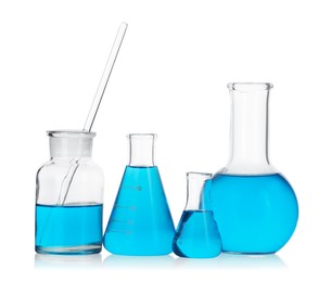 Photo of Laboratory glassware with blue liquid isolated on white