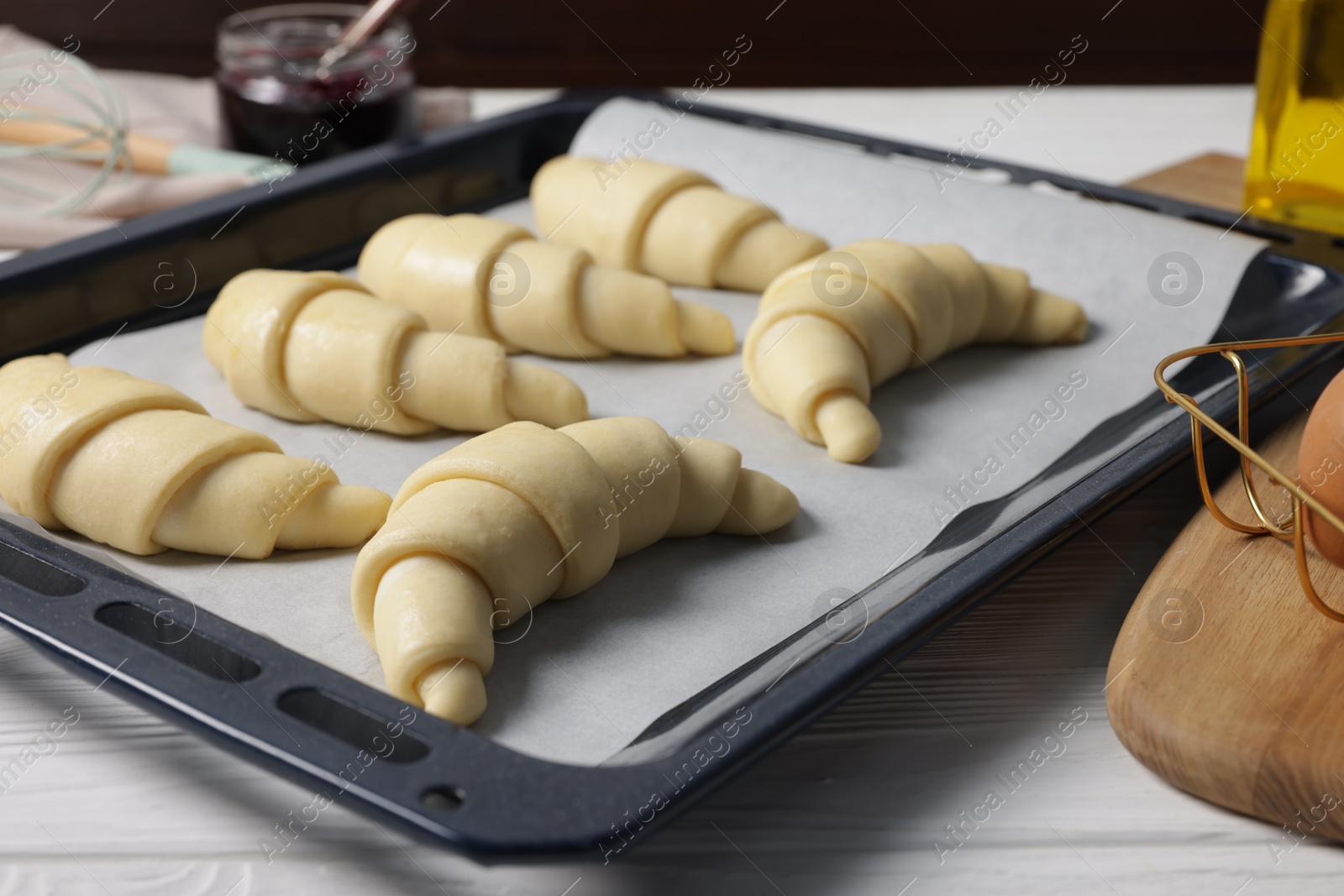 Raw croissants on white wooden table, closeup Photo of Raw croissants on white wooden table, closeup