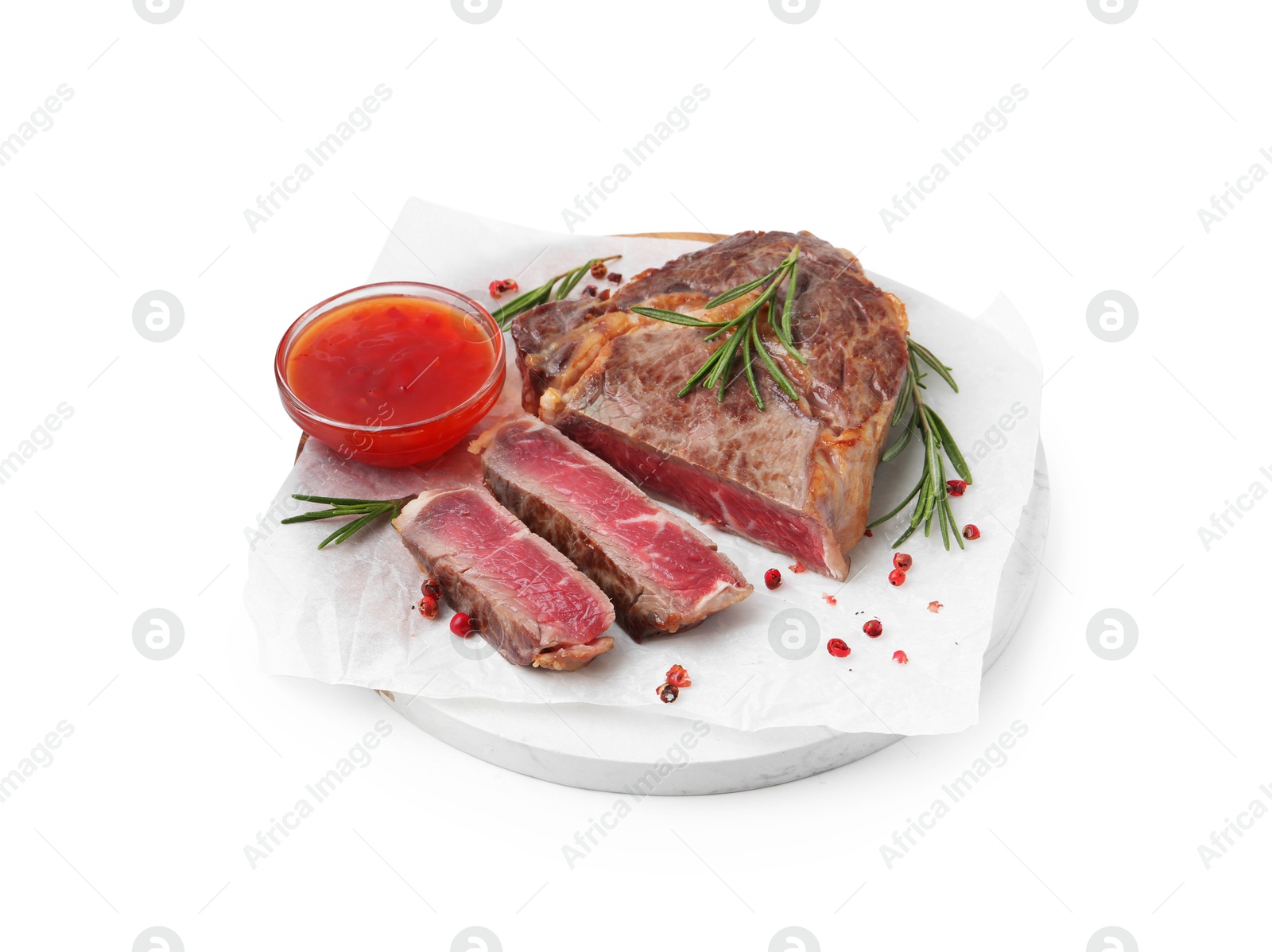 Photo of Pieces of delicious beef meat, spices and sauce isolated on white