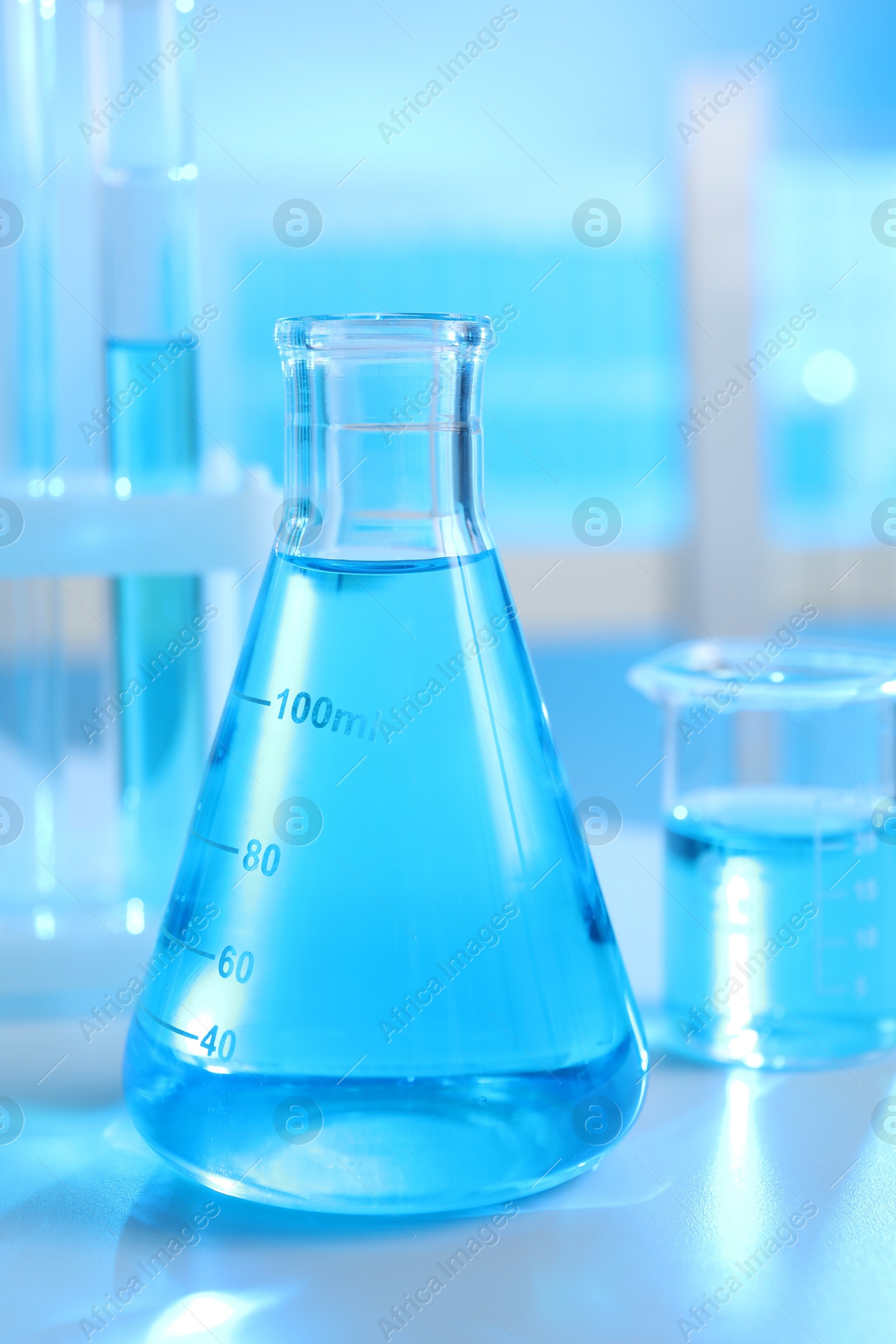 Photo of Laboratory glassware with liquid on table indoors