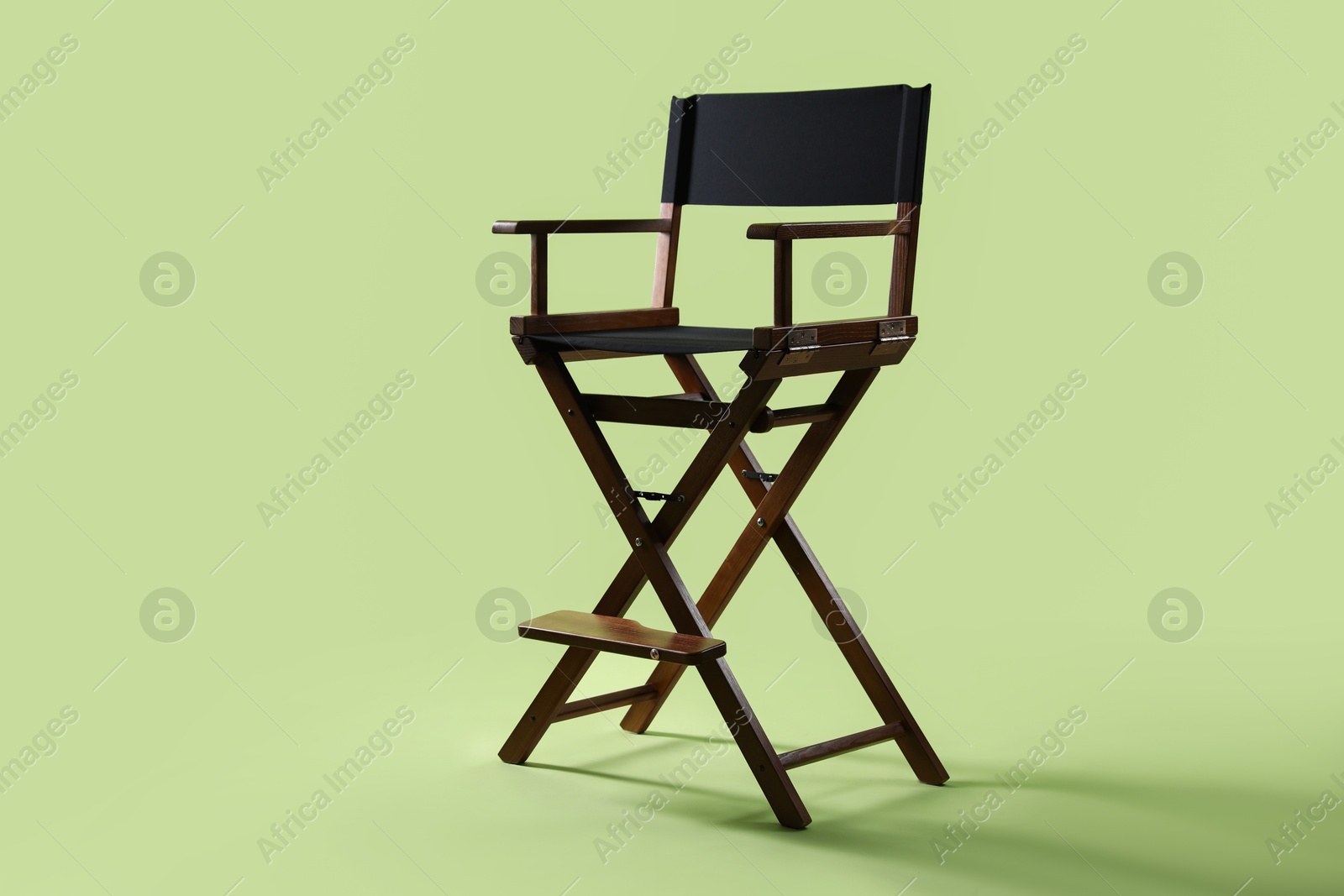 Photo of One empty director's chair on pale olive background