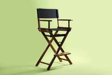 Photo of One empty director's chair on pale olive background