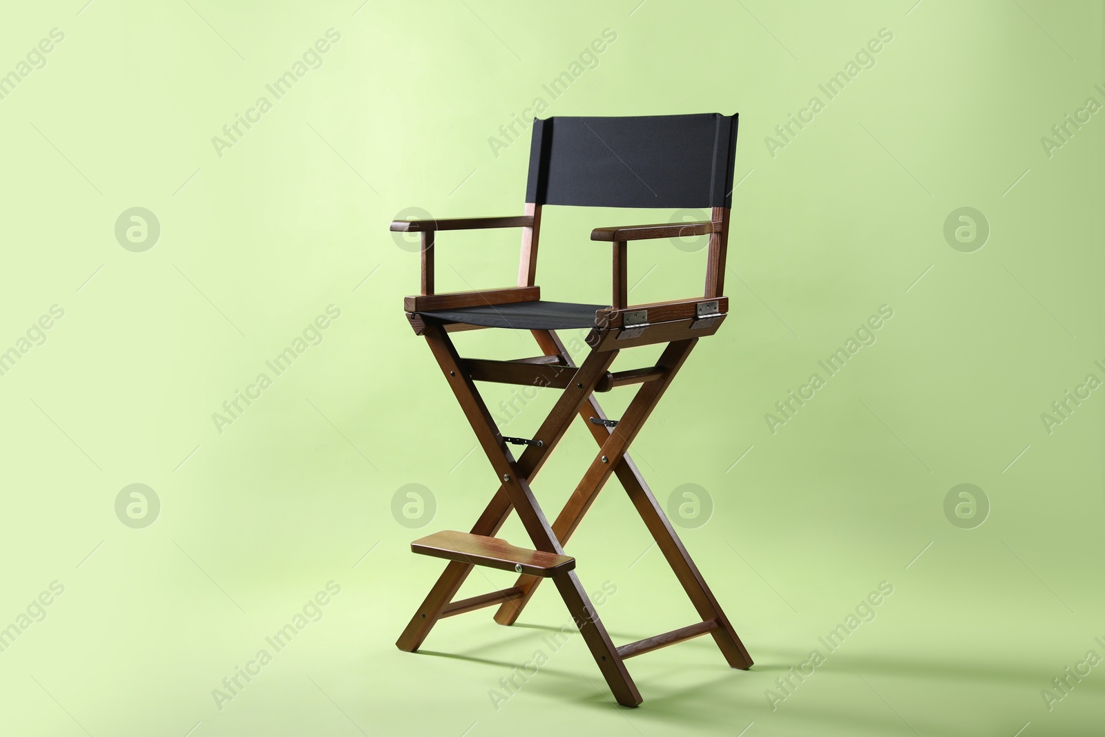 Photo of One empty director's chair on pale olive background