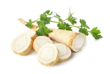 Photo of Fresh parsley and cut roots isolated on white