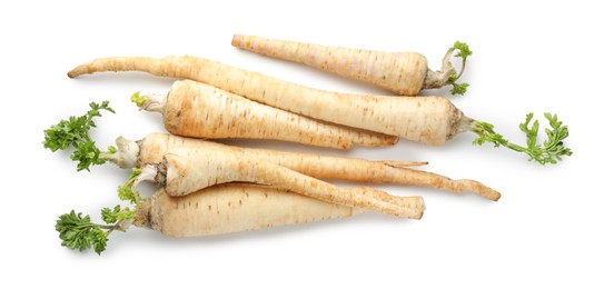 Photo of Many fresh parsley roots isolated on white, top view