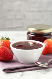 Photo of Delicious strawberry sauce and fresh berries on white marble table, closeup. Space for text