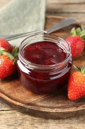 Photo of Delicious strawberry sauce and fresh berries on wooden table, closeup