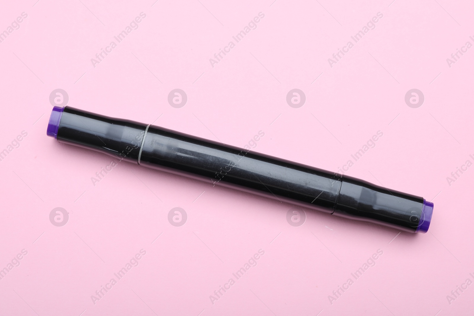 Photo of One double sided marker on pink background, top view