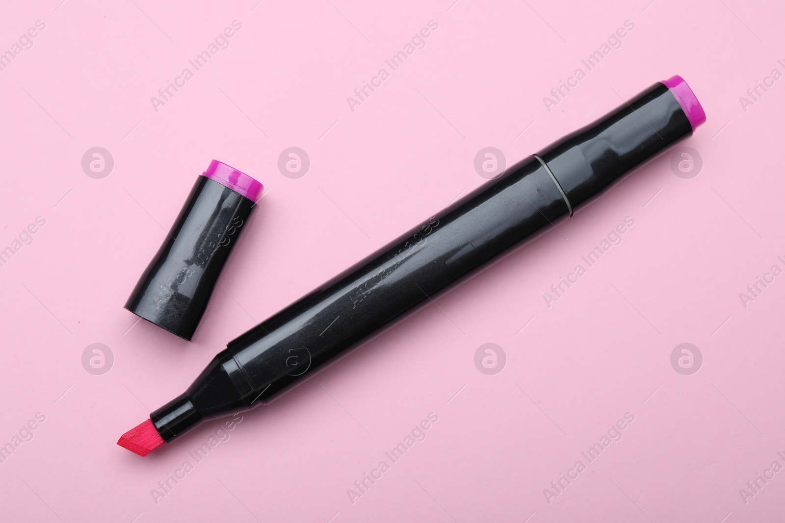 Photo of One double sided marker on pink background, top view