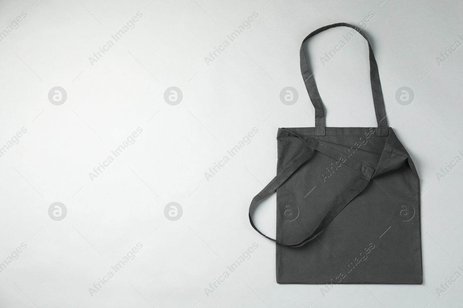 Photo of One shopping bag and space for text on grey background, top view. Mockup for design