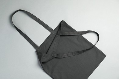 Photo of One shopping bag on grey background, top view. Mockup for design