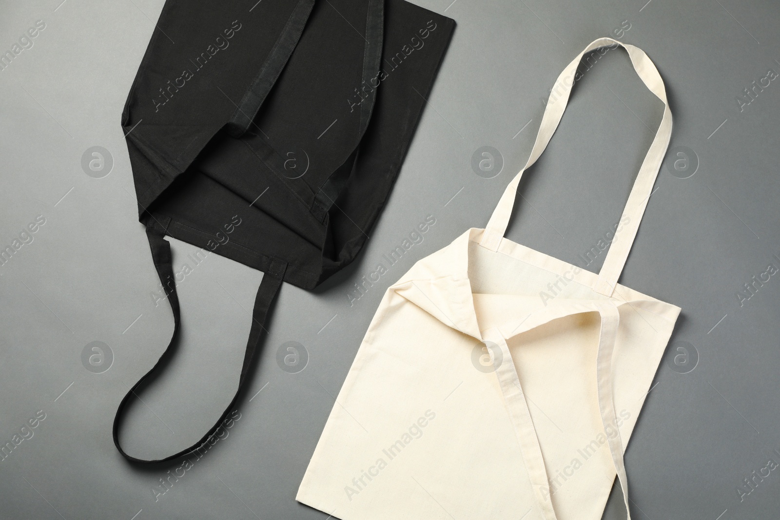 Photo of Shopping bags on grey background, flat lay. Mockup for design