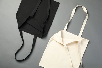 Photo of Shopping bags on grey background, flat lay. Mockup for design