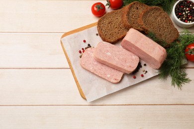 Pieces of tasty canned meat, tomatoes, peppercorns, dill and bread on light wooden table, flat lay. Space for text