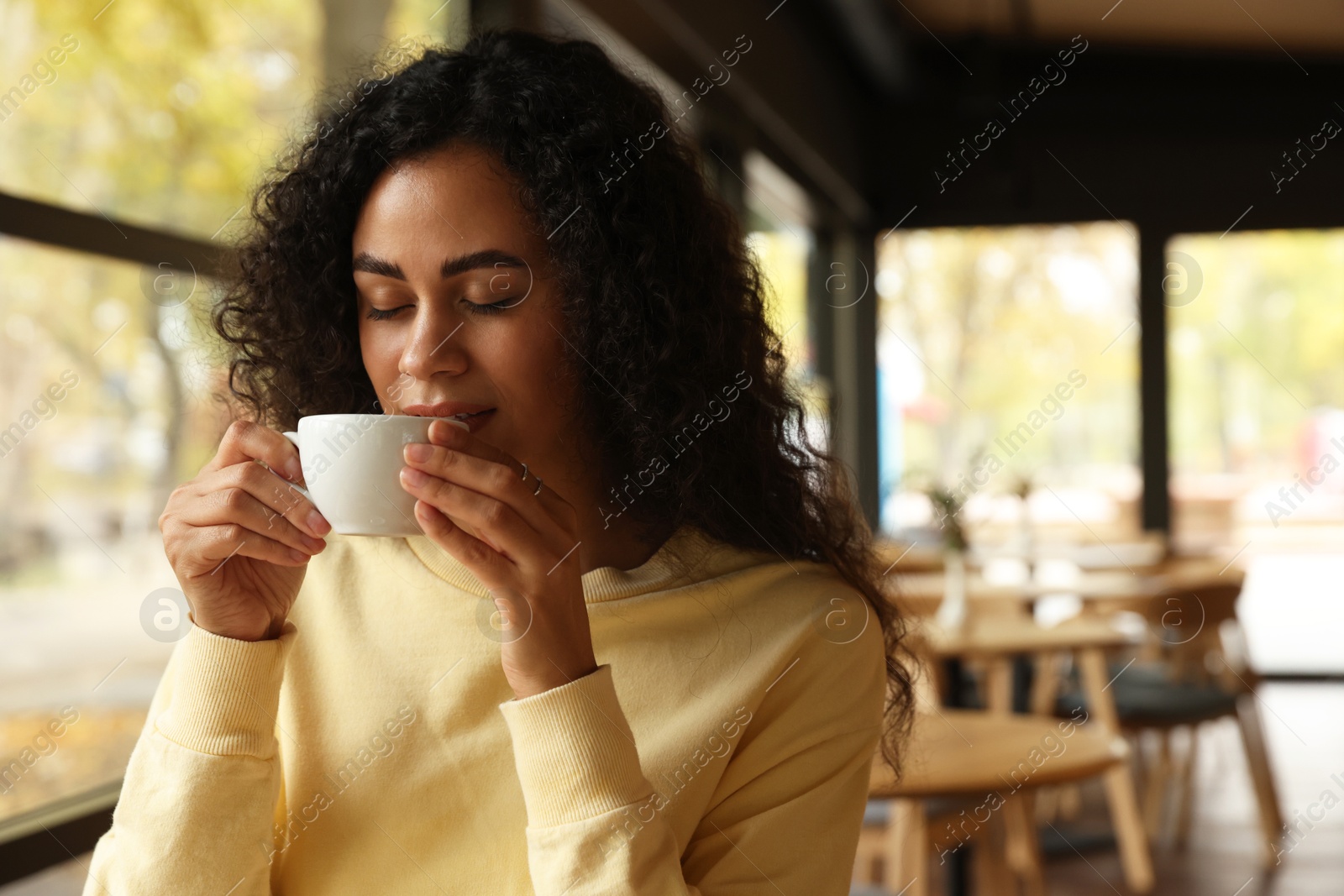 Photo of Woman enjoying her aromatic coffee in cafe