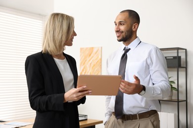 Photo of Coworkers with tablet working together in office