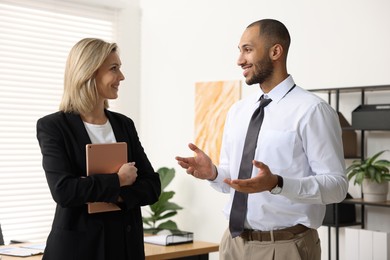 Happy coworkers talking in modern office. Working together