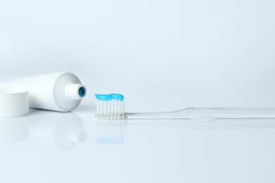 Photo of Toothbrush with toothpaste and tube on white background