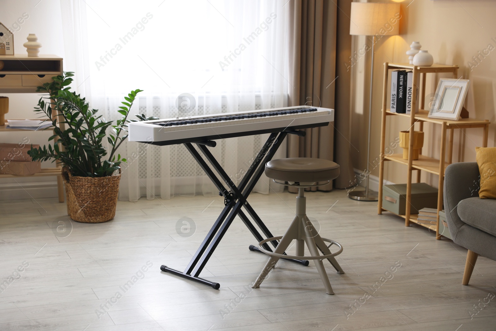 Photo of Synthesizer and stool indoors. Electronic musical instrument