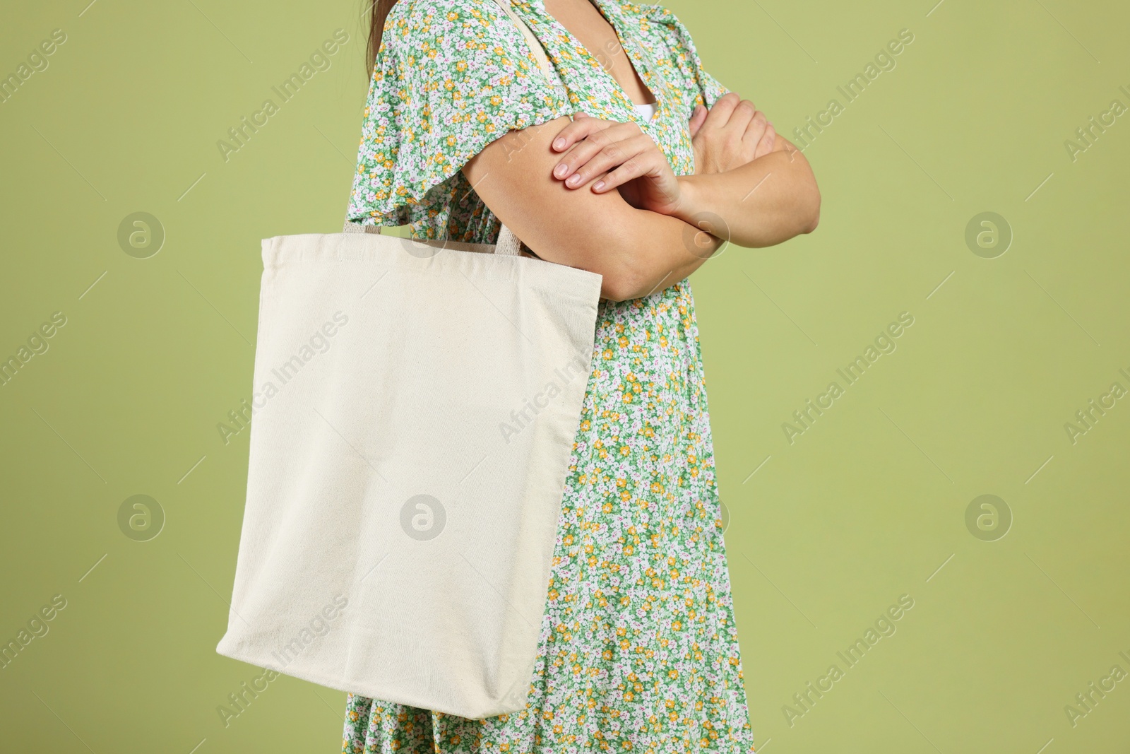 Photo of Woman with blank shopper bag on color background, closeup. Mockup for design