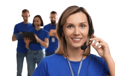 Photo of Technical support call center. Smiling operator on white background, selective focus