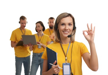 Photo of Technical support call center. Team of friendly operators on white background