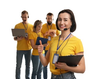 Photo of Technical support call center. Team of friendly operators on white background