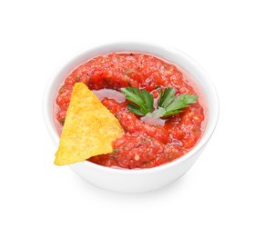 Photo of Delicious spicy salsa sauce with nacho chip in bowl isolated on white