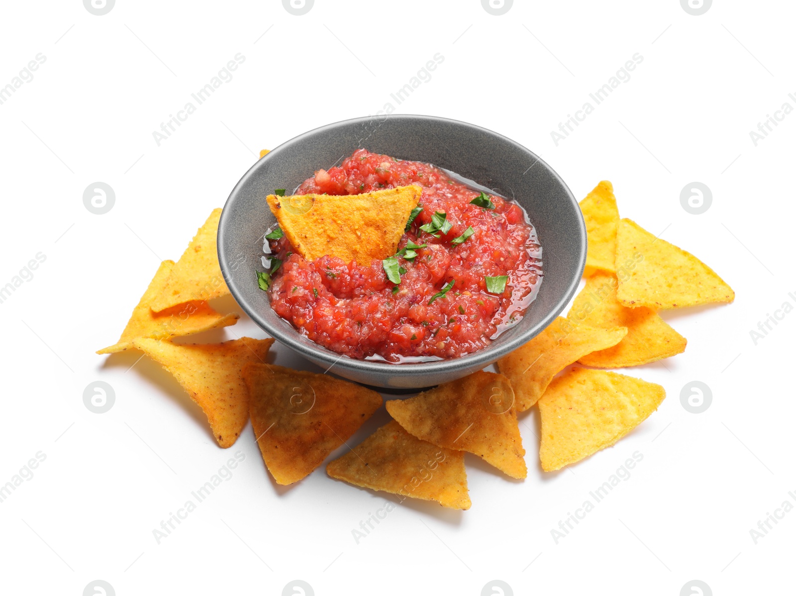 Photo of Delicious spicy salsa sauce in bowl and nacho chips isolated on white