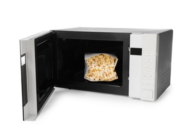 Photo of Open microwave oven with bag of popcorn isolated on white