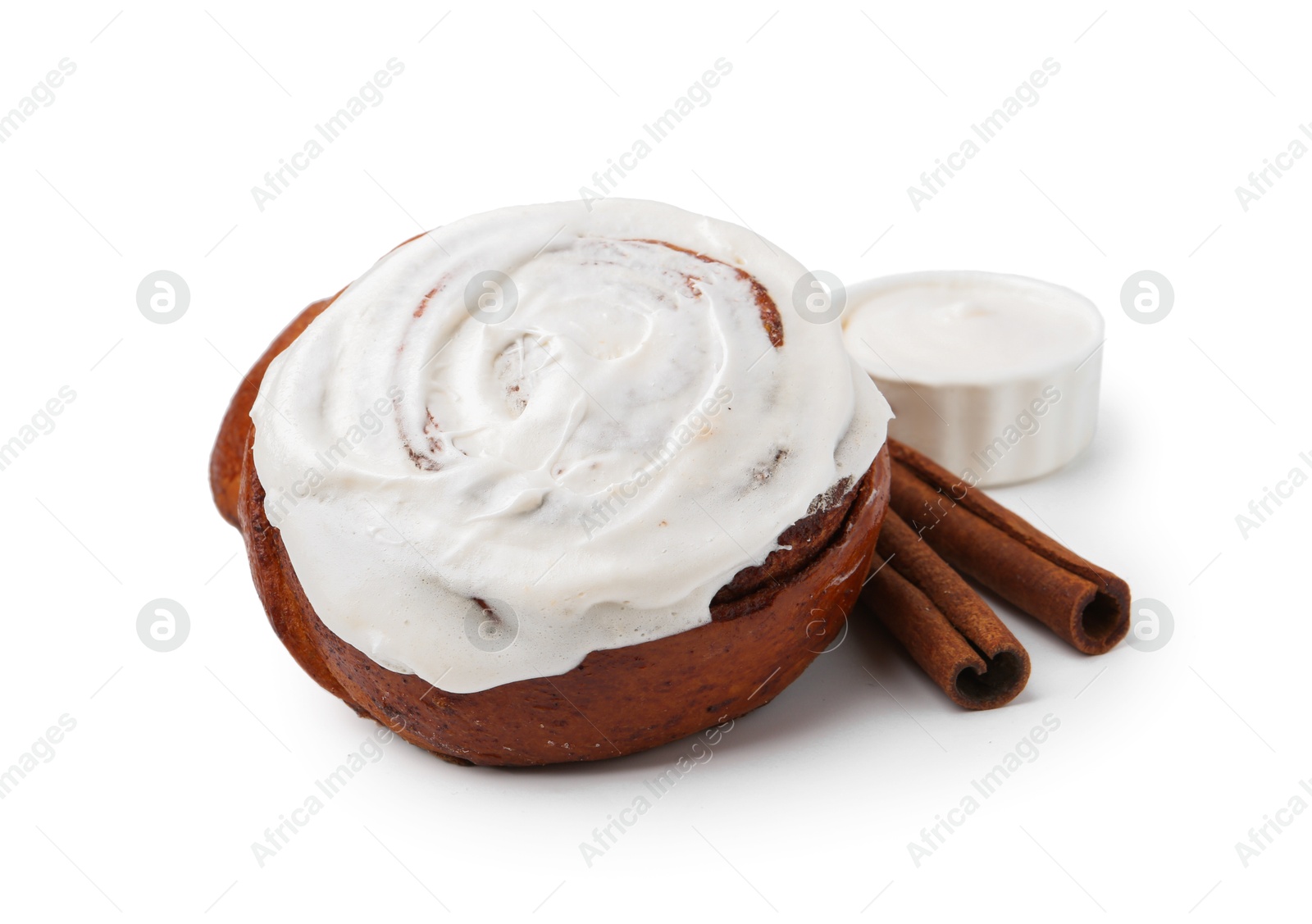 Photo of Tasty cinnamon roll with cream and sticks isolated on white