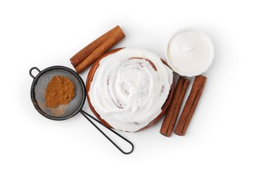 Photo of Tasty cinnamon roll with cream and sticks isolated on white, top view