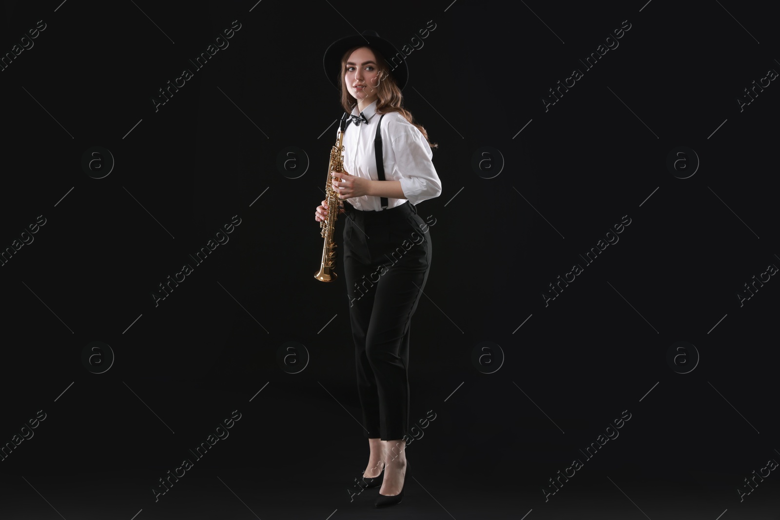 Photo of Musician with soprano saxophone on dark background