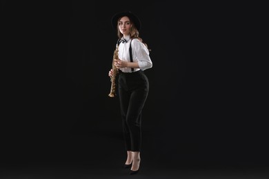 Photo of Musician with soprano saxophone on dark background