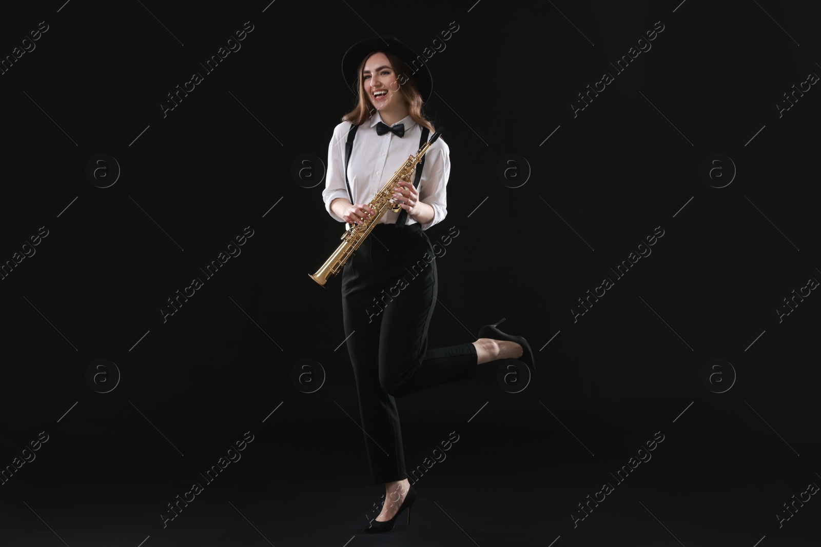 Photo of Musician with soprano saxophone on dark background