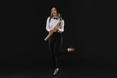 Musician with soprano saxophone on dark background