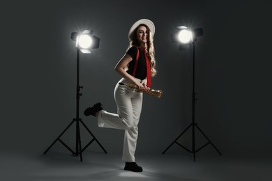 Photo of Musician with soprano saxophone on grey background