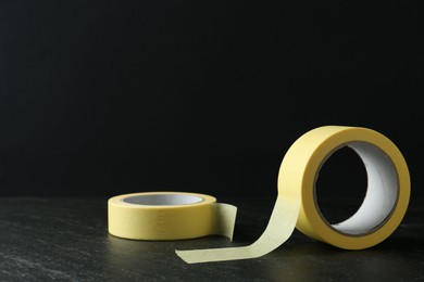 Rolls of masking tape on black table